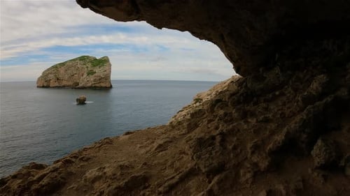 Cave on Rocky Coast with Cliffs on the Mediterranean Sea