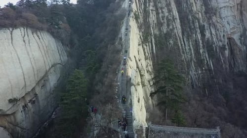 Tourists climb knife edge granite steps high on Mt Huashan in China