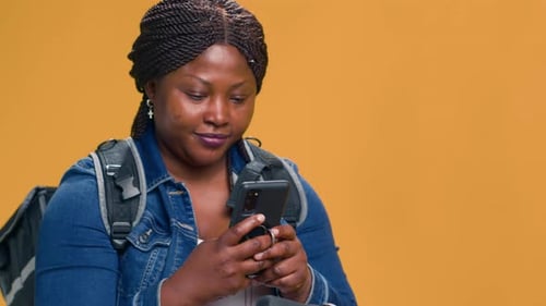 Woman on Bicycle Looking at Phone