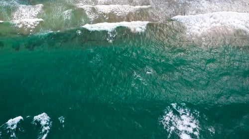 Aerial View of the Mediterranean Coast Waves Reach the Deserted Sandy Beach