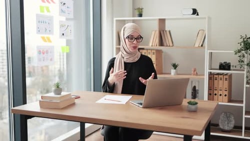 Businesswoman Getting Video Call on Computer in Office