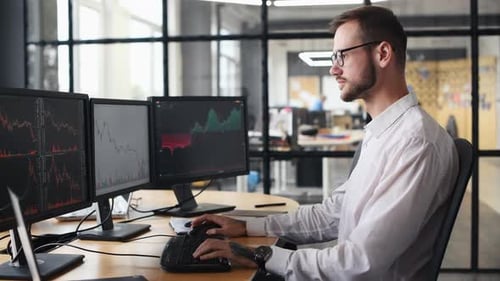 Trader Celebrates Business Success at Computer Workstation