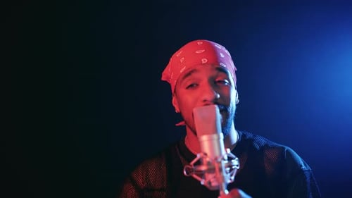Young Rapper Singing a Song Into a Studio Microphone