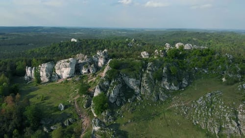 Rocky Hill Covered With Forest - Drone. Aerial view of a nature park with lot of large stones and ro