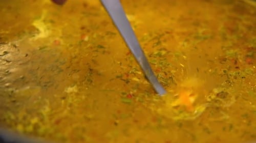 Vegetable Soup with Carrots and Dill Being Stirred