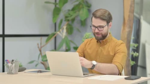Online Video Chat by Young Man in Office