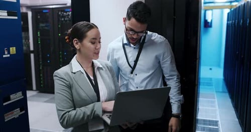 Two Colleagues Working on Laptop in Server Room