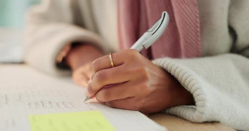 Writing in Notebook at the Office Close Up