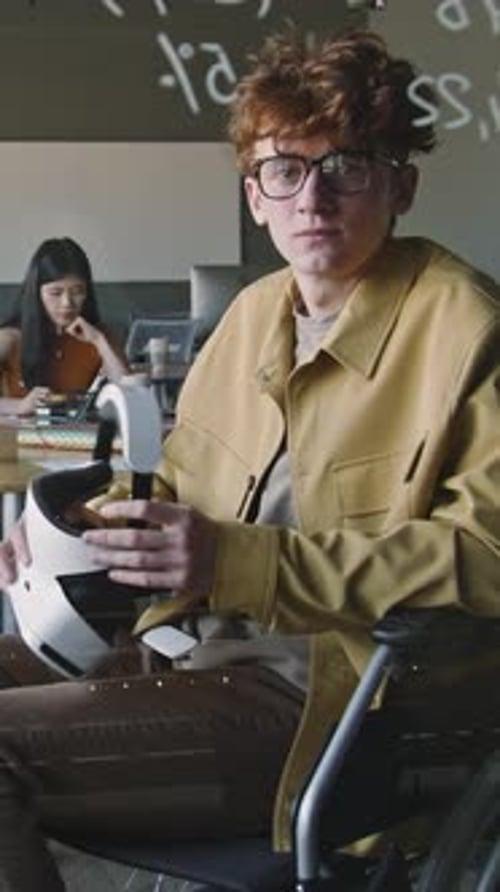 Portrait of Young Man in Wheelchair with VR Headset in Office of IT Company