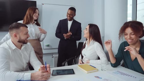 Smiling Team Celebrating Success in Modern Office