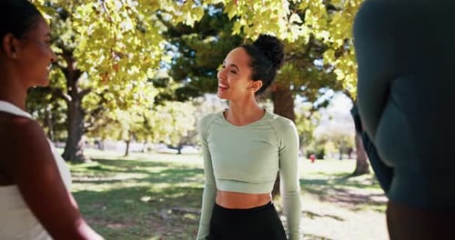 Young Women Stretching Together in the Park