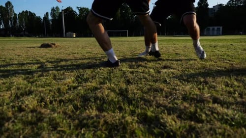 Two Sportsmen Playing in Soccer in Stadium at Sunset Professional Footballers Performing Tricks with
