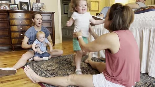Family Plays on Floor Together in Bedroom