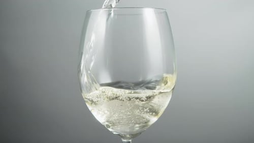 Close Up Glass of Sparkling Wine Being Poured