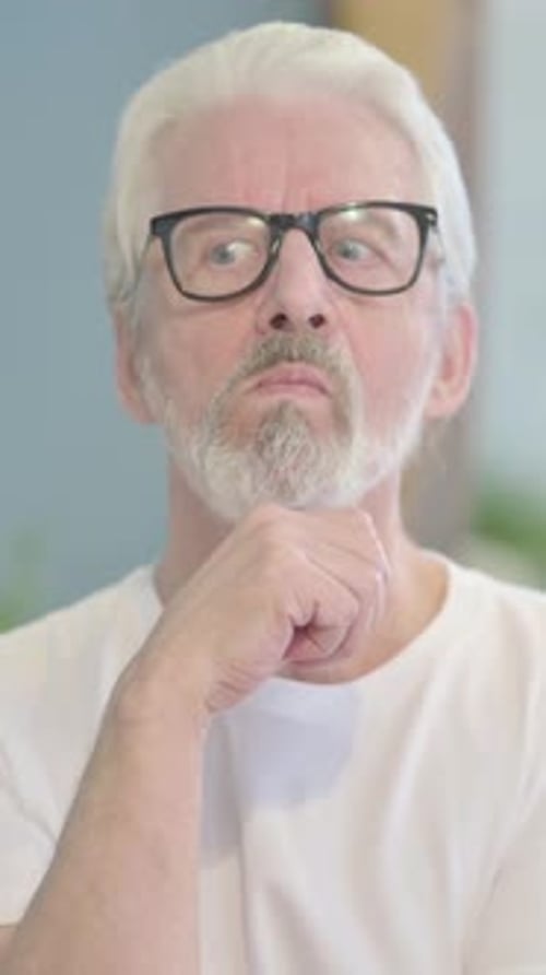 Senior Man in Glasses Has an Idea