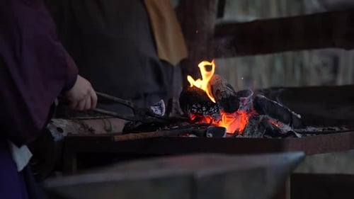 Blacksmith Shaping Metal at Anvil in Rural Forge