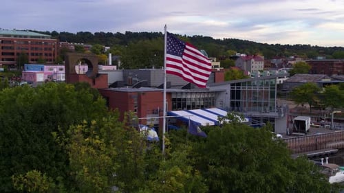 Aerial view of American flag waving near harbor