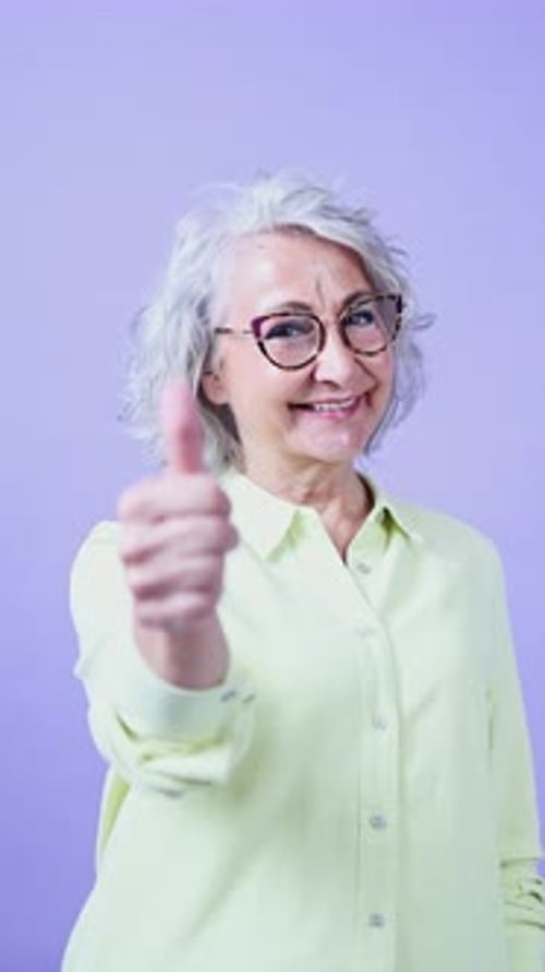 Senior Woman Smiling and Giving a Thumbs Up Gesture