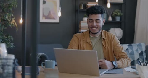Young Adult Working on Laptop at Home