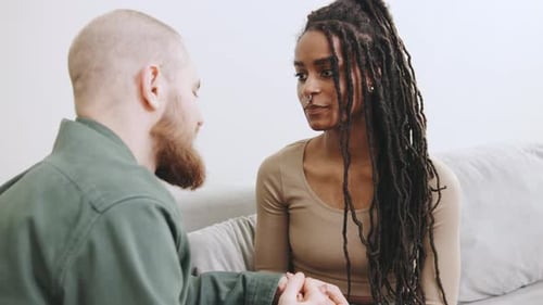 Couple Holding Hands and Talking Intimately