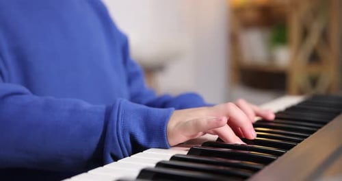 Child Plays Piano in Home, Close Up Shot