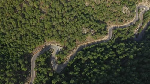 White Car Driving on Winding Mountain Road