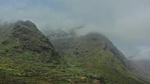 Lush Mountainside with Misty Clouds Aerial Shot
