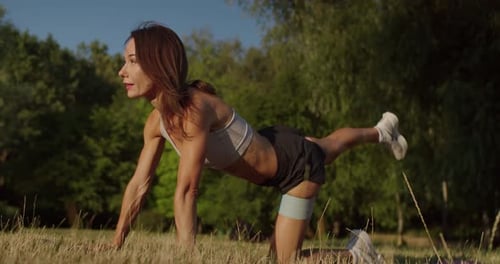 Fit Woman Exercising with Resistance Band Outdoors