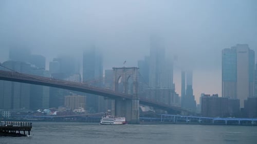 Foggy Brooklyn Bridge and Lower Manhattan. Brooklyn Bridge leading toward Lower Manhattan
