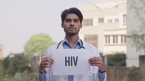 Indian Doctor Holding HIV Poster