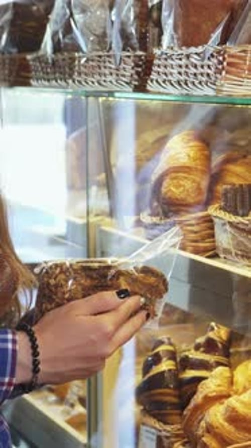 Enthusiastic Woman Selecting Delectable Cookies at a Charming Bakery
