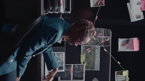 Woman Works to Solve Crime with Evidence Board