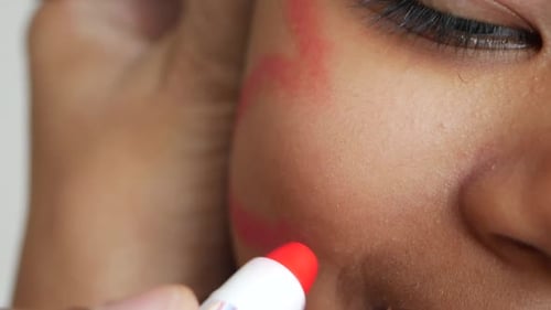 CloseUp of a Child's Face Being Painted with Vibrant Artistic Colors