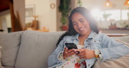 Woman Relaxes On Sofa While Using Phone