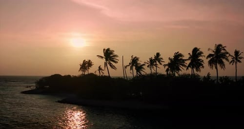 Aerial view of scenic sunset landscape of desert island with white sand beach, crystal clear sea w