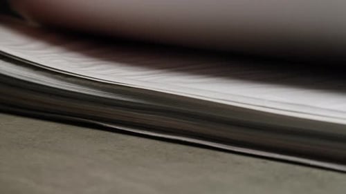 Hands Flipping Through Pages of a Document