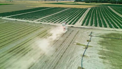 Tractor Working in a Field Surrounded by Farmlands - Aerial View 2K