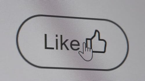 Clicking like button on the computer screen