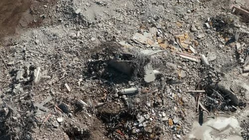 Demolition Site After Excavators Working on Large Area of Debris and Dirt Ground is Covered in