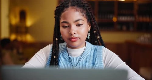 Freelancer, thinking and woman with laptop in restaurant for remote work, website and communication