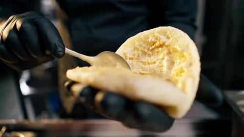 Preparing Pita Sandwich with Sauce in Kitchen