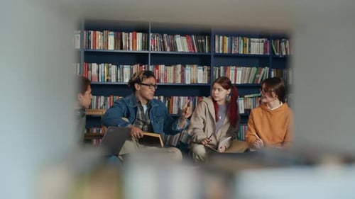 Motivated Multiethnic Students Hanging Out in Comfortable Modern Library