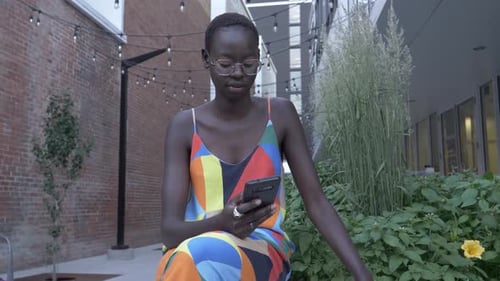 Stylish Beautiful Young Woman Using Smart Phone in Urban Courtyard Adult