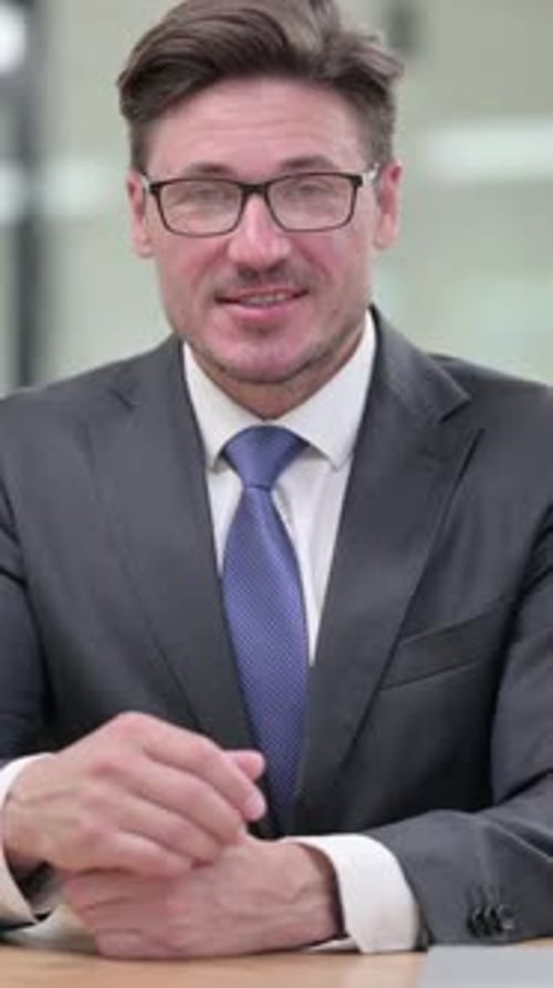 Positive Middle Aged Businessman doing Video Chat in Office, vertical video