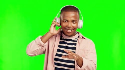 Music headphones, dance and black man on green screen in studio isolated on a background