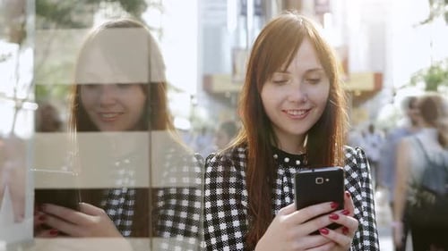 Young Caucasian Woman Chatting on Mobile Phone Device