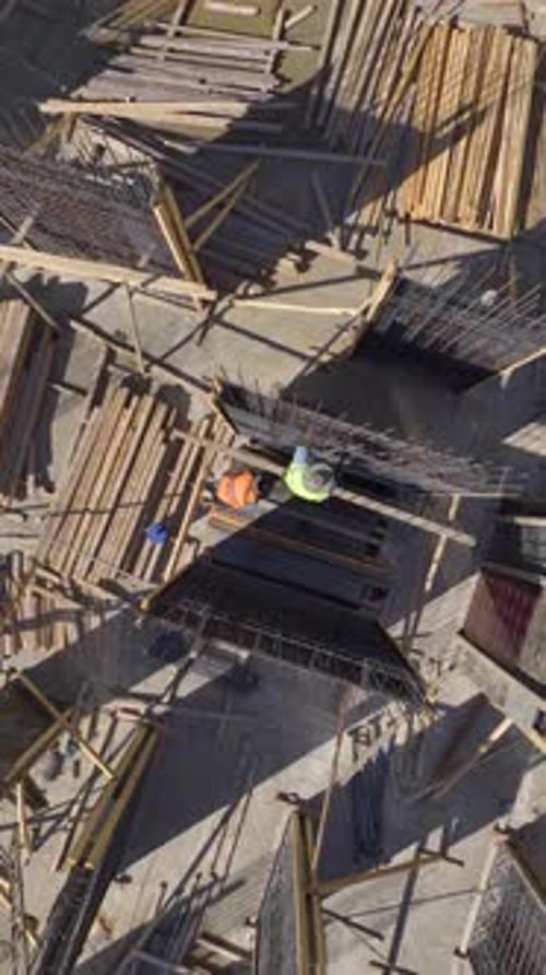 Vertical Video Active Construction Site Features Workers Laying Bricks and Building Walls with