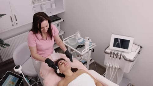 Woman Receives a Facial Treatment in Bright Medical Office