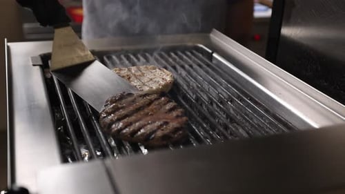 Burger Patties Sizzle on Stainless Steel Grill