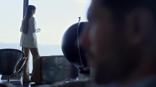 Stressed Executive Thinking in Dark Hotel Lounge